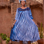 Loosely flared tent dress, 3/4 sleeves, graded hemline below the calf