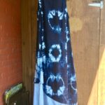 Calf- length sleeveless dress with round neck, with detachable underskirt / scarf